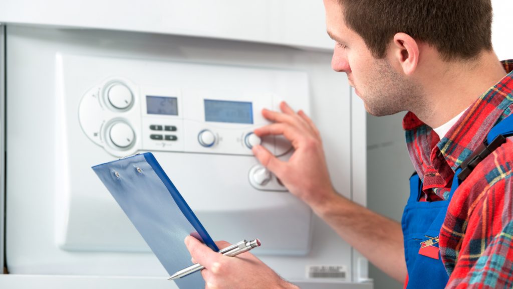 Technician servicing heating boiler